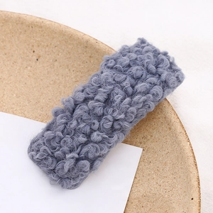 Close-up of grey blue teddy plush square hair clip on decorative plate