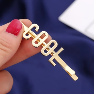 Fermaglio per capelli in lega d'oro lucido con scritta COOL su sfondo blu scuro