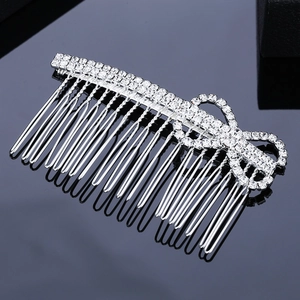 Peigne à cheveux de mariée avec strass et nœud élégant sur surface miroir noire