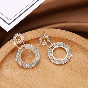 Fashionable gold circular earrings with pavé rhinestones in a minimalist geometric design