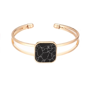 Minimalist double-layered gold open bangle with a square black marble stone insert