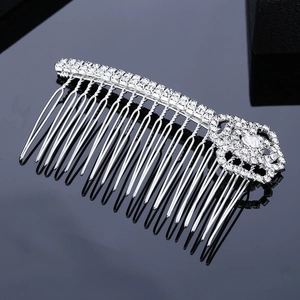 Silver bridal hair comb with elegant rhinestones and floral crystal accents on black background
