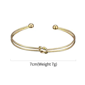Minimalist gold double-layer knot cuff bracelet with ball accents and 7cm diameter