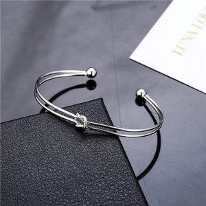 Minimalist double layer silver knotted open bangle featuring round beads and polished finish