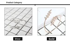 Detail view of silver and gold leaf-shaped open bangles with crystal micro-pave stones