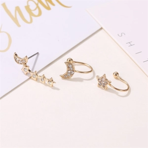 Macro view of gold-plated star and moon ear cuff set with pavé cubic zirconia