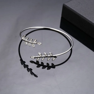 Silver leaf cuff bracelet with sparkling cubic zirconia on a black reflective background