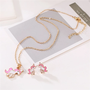 Détail d'un ensemble bijoux licorne blanche avec crinière rose et collier doré