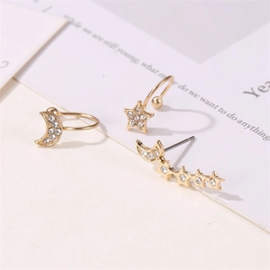 Macro shot of three-piece gold ear cuff set with rhinestones in star and moon designs