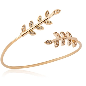 Elegant gold open leaf bracelet with sparkling rhinestones on a white background