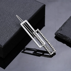 Silver square hair clip with sparkling rhinestones for women on black texture background