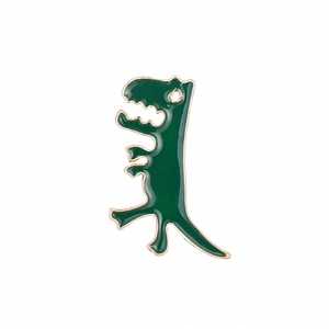Cute green enamel dinosaur brooch with golden metallic edges on a clean white background