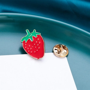Cute strawberry enamel brooch in red and green with a gold butterfly clutch backing