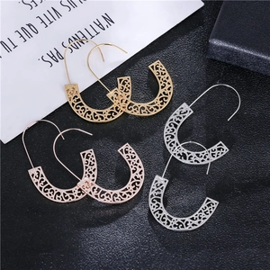 Three pairs of geometric hollow pattern earrings in gold silver and rose gold finishes