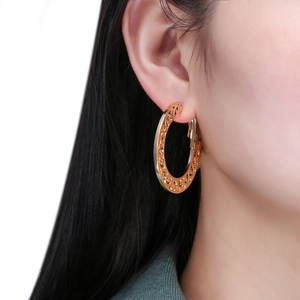 Bohemian gold hollow hoop earrings featuring intricate vintage floral filigree patterns