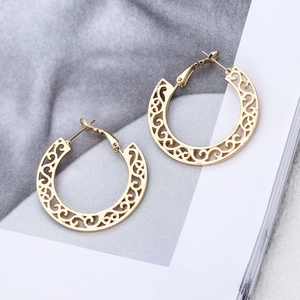 Golden bohemian hollow-out C-shaped earrings with intricate filigree patterns