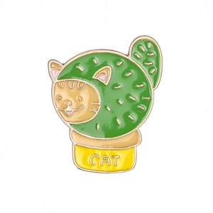 Cartoon enamel pin featuring a cat in a green cactus costume with yellow pot base