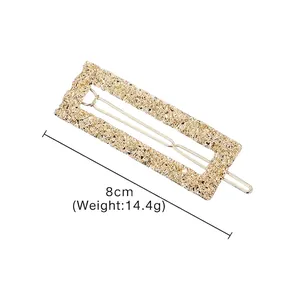 Three-piece gold metal rectangular hair clips with floral embossing, 8cm long design