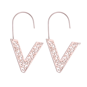 Rose gold V-shaped drop earrings with hollow floral pattern and long hooks on white background