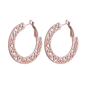Detail view of Bohemian rose gold hollow hoop earrings with intricate vine patterns