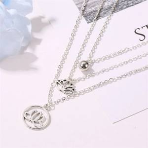 Three-layer silver lotus necklace featuring a circular pendant and minimalist metal bead