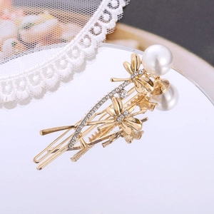 Elegante fermaglio per capelli a libellula color oro con strass lucidi e una perla bianca