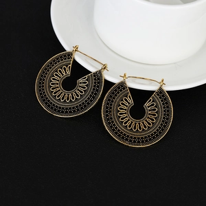 Bohemian vintage hollow metal hoop earrings with ethnic wave patterns in bronze gold
