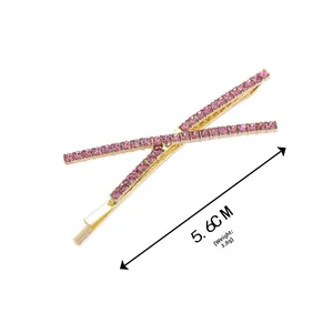 Close-up of golden X-shaped hair clip with pink rhinestones, size 5.6cm and weight 3.8g