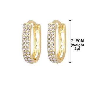 Détail de boucles d'oreilles dorées en U avec double rangée de cristaux, hauteur 2,8 cm