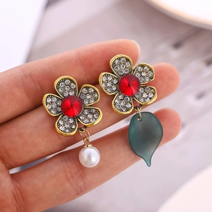 Asymmetric floral earrings with rhinestones, red gemstone, pearl and leaf charms