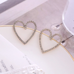 Elegant 925 silver heart stud earrings with sparkling crystals in a golden setting
