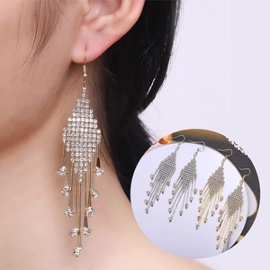Detail view of long rhinestone tassel earrings in gold and silver finish options