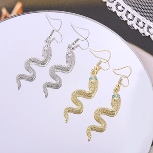 Chic snake drop earrings in gold and silver finish with detailed scale texture and blue eyes