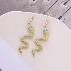 Golden snake hoop earrings with blue rhinestone eyes and textured scale detail