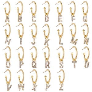 Detail view of gold letter earrings set featuring 26 sparkling A-Z alphabet charms with gems