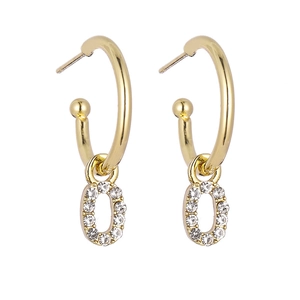 Detail of gold hoop earrings with crystal-encrusted letter O pendant and polished finish