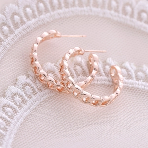 Rose gold chain-link hoop earrings in minimalist C-shape on elegant white lace fabric