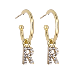 Detail view of gold hoop earrings with sparkling crystal letter R pendant charms