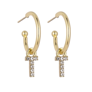 Detailed view of gold hoop earrings with sparkling crystal-encrusted letter T pendants