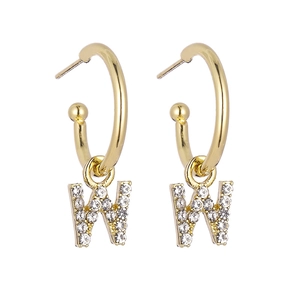 Detailed view of gold C-shaped hoop earrings featuring crystal-encrusted letter W charms