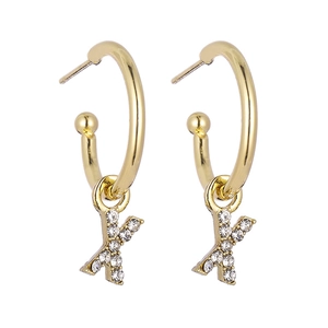 Close-up of gold letter K earring with sparkling zircons and a smooth hoop dangle