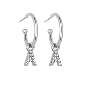 Detail view of silver letter A earrings featuring sparkling stones and classic hoop design