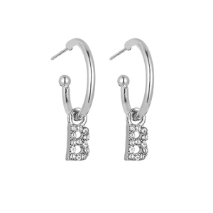 Detail view of silver hoop earrings with sparkling crystal letter B pendant