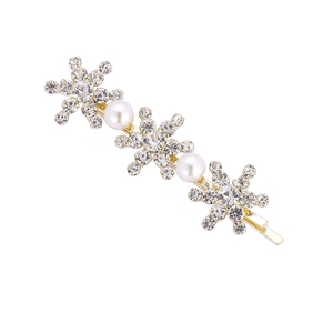 Barrette à cheveux dorée avec des flocons de neige en strass et perles blanches