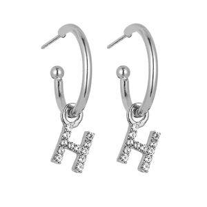 Detailed view of silver C-hoop earrings with sparkling pave letter H pendant and studs