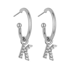 Close-up of silver letter K hoop earrings with sparkling crystal pavé stones