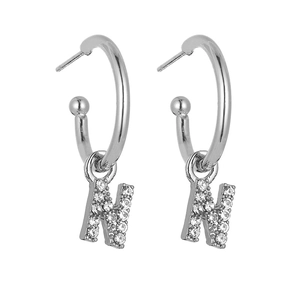 Close-up of silver letter N hoop earrings with pavé set shimmering cubic zirconia