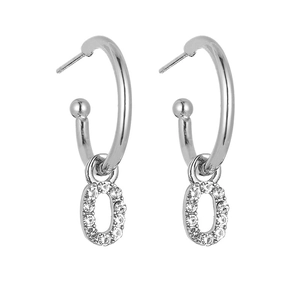 Detailed close-up of C-shaped silver earrings with sparkling letter O crystal charms
