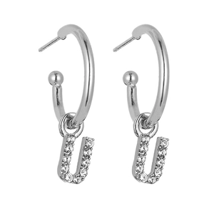 Detail of silver letter U earrings with pave set sparkling zircons in a C-shaped hoop style