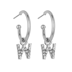 Macro detail of silver letter W earrings with micro-paved sparkling cubic zirconia stones